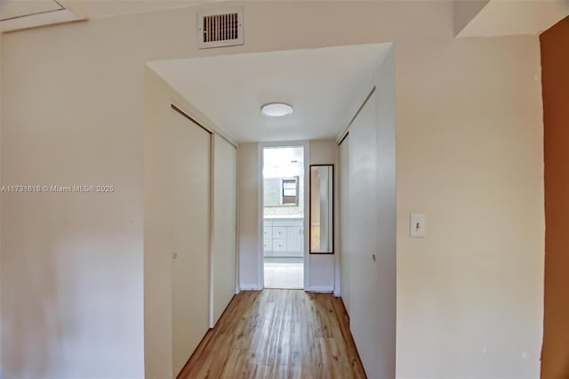 corridor with light wood-type flooring