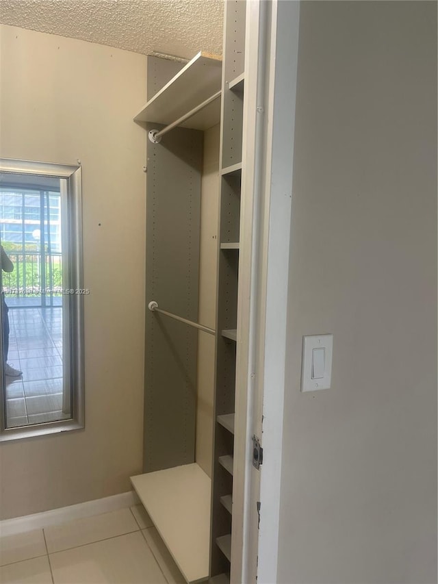 spacious closet featuring tile patterned flooring