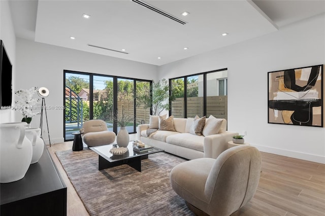 living room featuring plenty of natural light and light hardwood / wood-style flooring