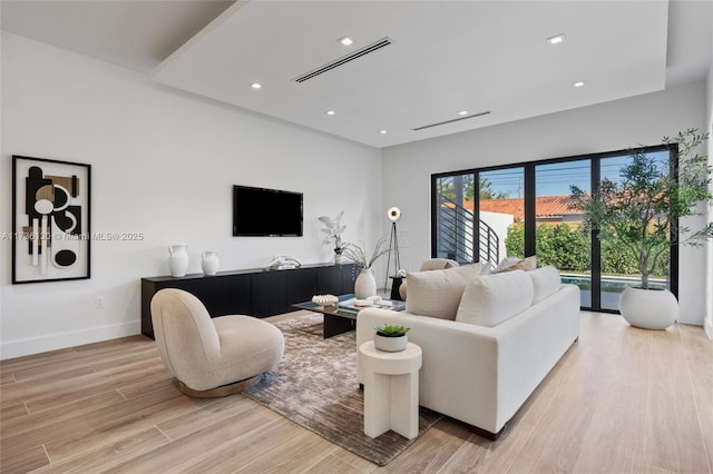 living room with light hardwood / wood-style flooring