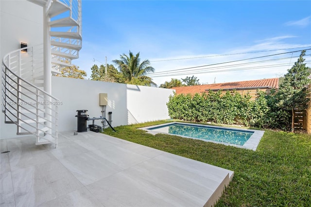 view of swimming pool with a yard and a patio area