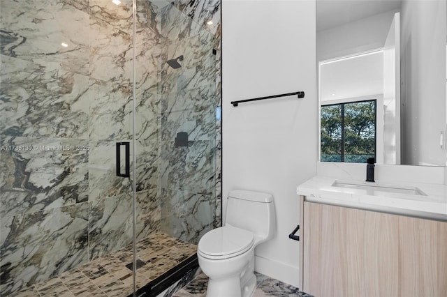 bathroom featuring vanity, toilet, and a shower with door