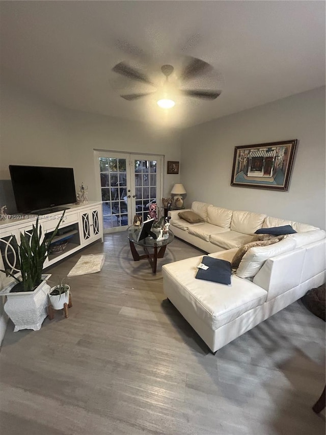 living room with hardwood / wood-style flooring, french doors, and ceiling fan