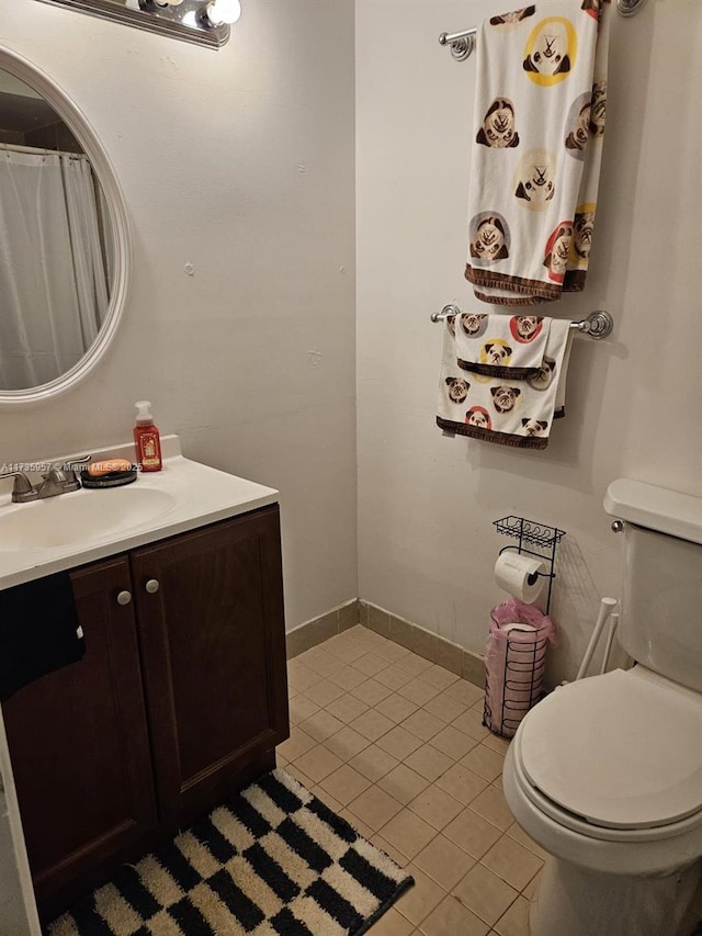 bathroom with vanity, tile patterned flooring, and toilet