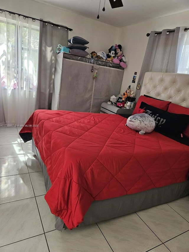 bedroom featuring ceiling fan and tile patterned flooring