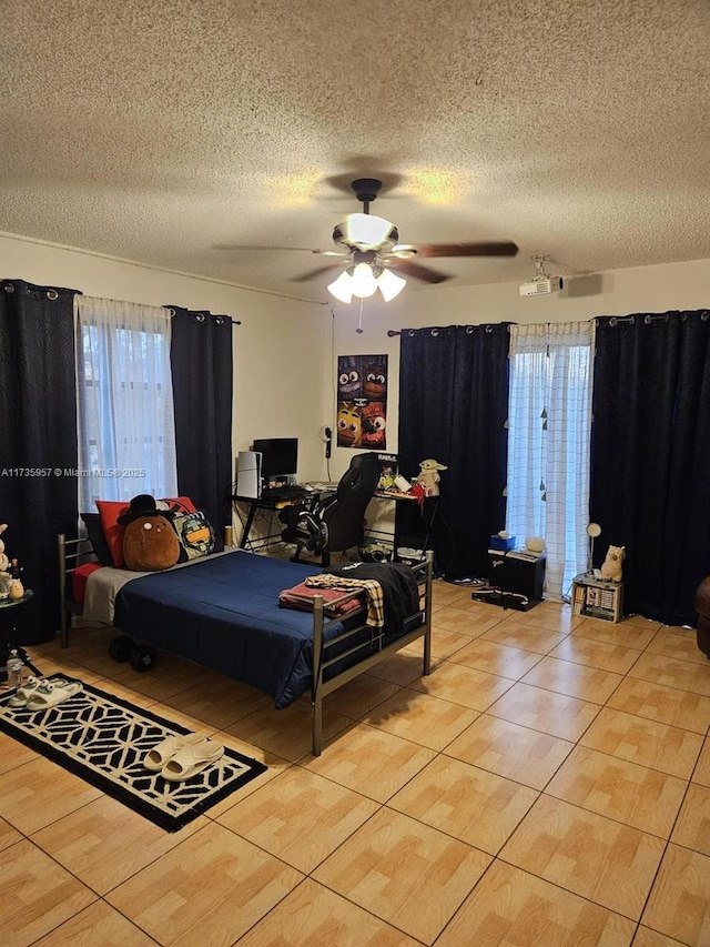 tiled bedroom with a textured ceiling and ceiling fan