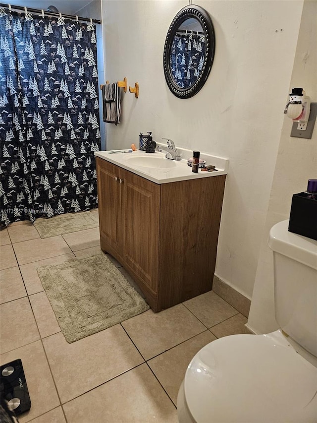 bathroom featuring tile patterned flooring, vanity, and toilet