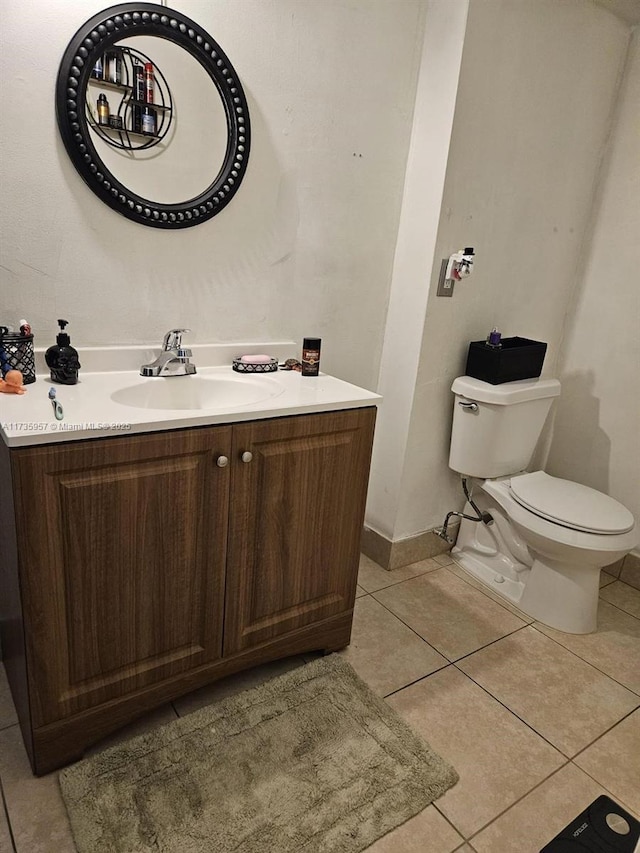 bathroom with tile patterned floors, toilet, and vanity