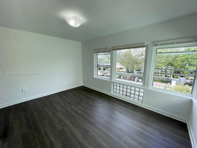 unfurnished room with dark hardwood / wood-style floors