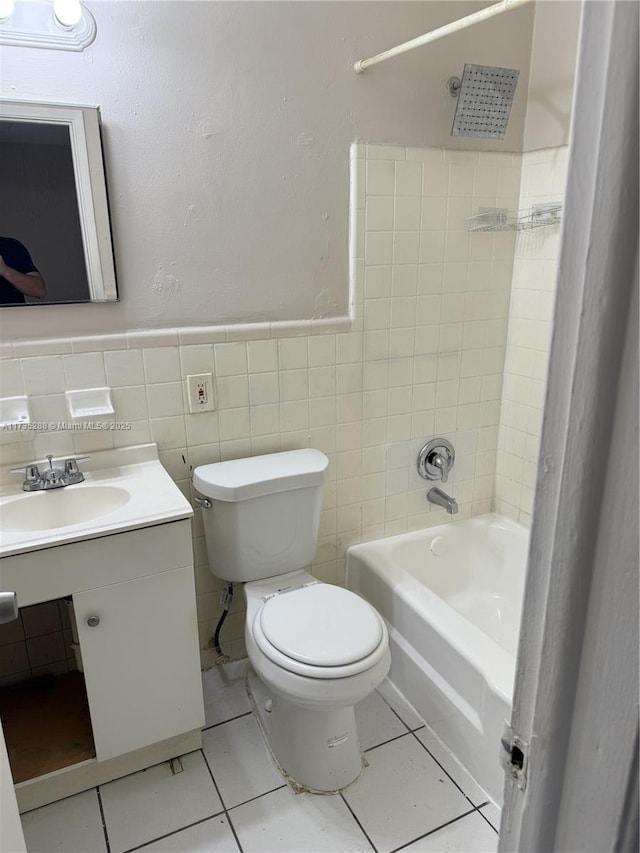 full bathroom with tile patterned floors, toilet, tiled shower / bath combo, and vanity