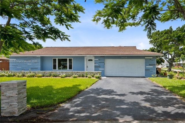 single story home featuring a garage and a front yard