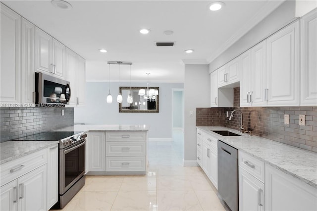 kitchen with decorative light fixtures, white cabinetry, sink, stainless steel appliances, and crown molding