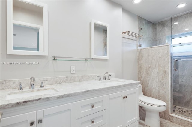 bathroom featuring vanity, walk in shower, and toilet