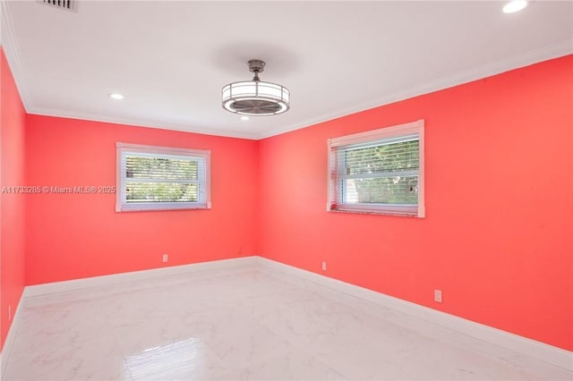 empty room featuring crown molding