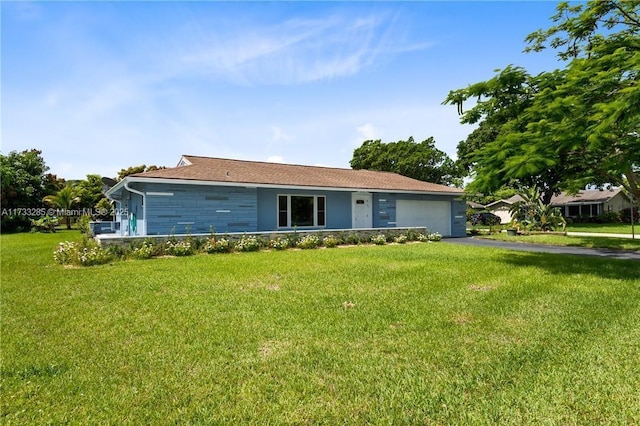 ranch-style home featuring a garage and a front yard