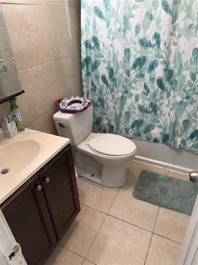 full bathroom with tile walls, tile patterned flooring, vanity, toilet, and shower / bathtub combination with curtain