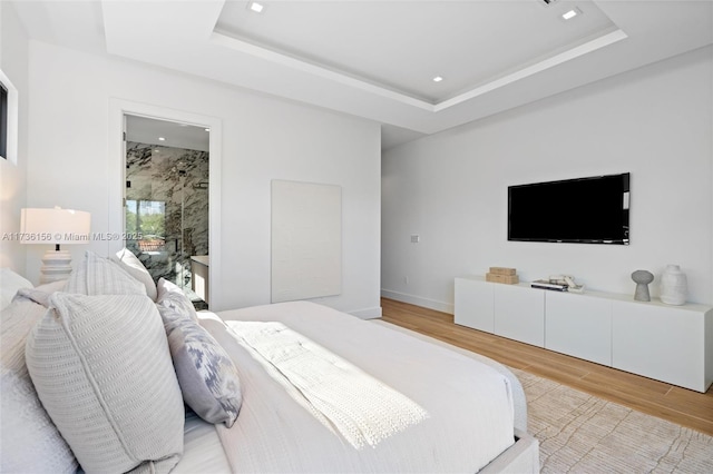 1247 SW 13th Ave, Miami, FL 33135 - bedroom featuring light wood-style floors, a tray ceiling, recessed lighting, baseboards, and ensuite bath