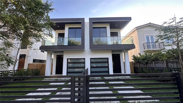 1247 SW 13th Ave, Miami, FL 33135 - modern home with stucco siding, a fenced front yard, and a balcony