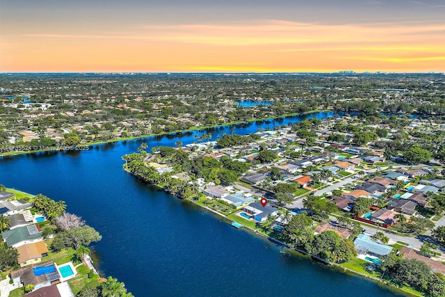 aerial view at dusk with a water view