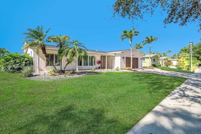 ranch-style home with a garage and a front lawn