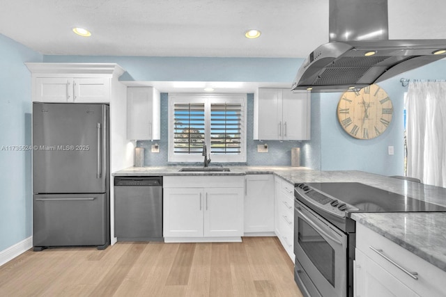 kitchen featuring sink, appliances with stainless steel finishes, white cabinetry, island exhaust hood, and light wood-type flooring