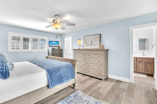 bedroom featuring connected bathroom, sink, light hardwood / wood-style flooring, a closet, and ceiling fan