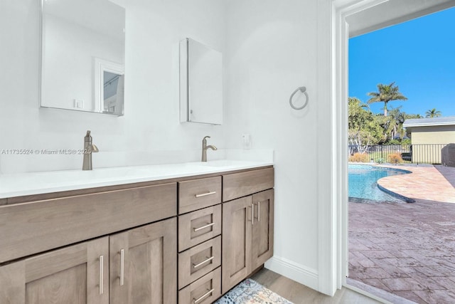 bathroom with vanity and wood-type flooring