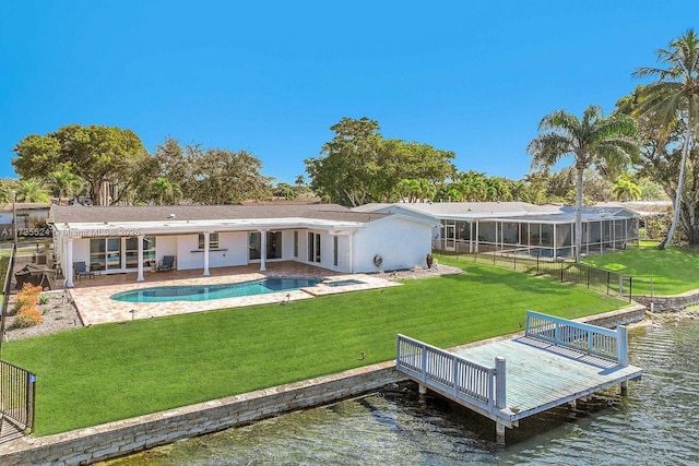 back of house with a water view, a yard, and a patio