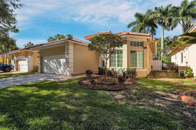 mediterranean / spanish-style home featuring a garage and a front yard