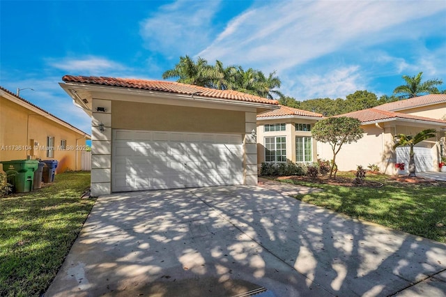 mediterranean / spanish house with a garage and a front yard