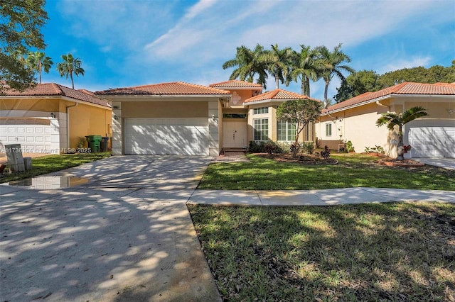 mediterranean / spanish-style home with a garage and a front lawn