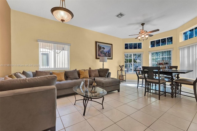 tiled living room featuring ceiling fan and a healthy amount of sunlight