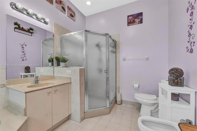 bathroom with toilet, vanity, walk in shower, a bidet, and tile patterned floors