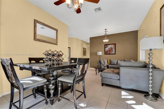 tiled dining area with ceiling fan