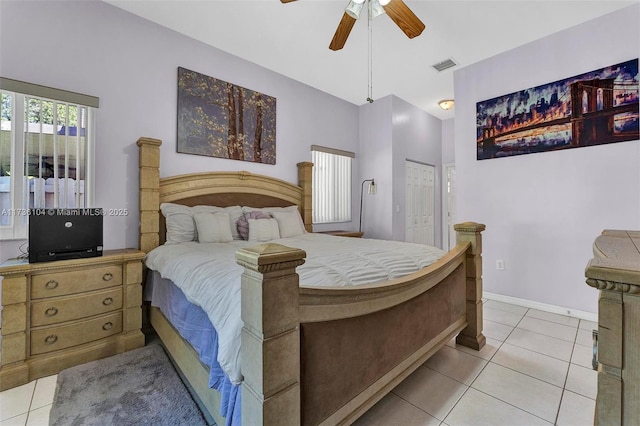 tiled bedroom featuring ceiling fan, lofted ceiling, and a closet