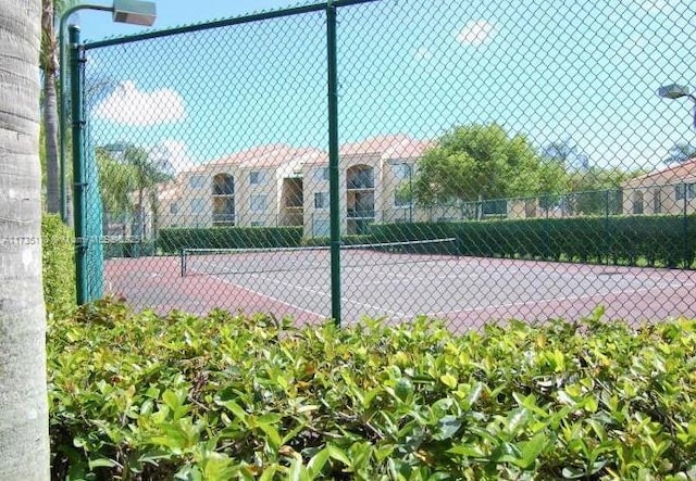 view of sport court with fence