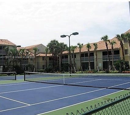 view of tennis court featuring fence