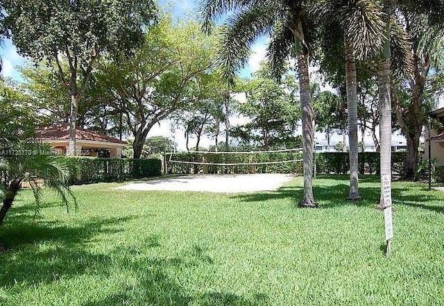 view of community with a yard and volleyball court