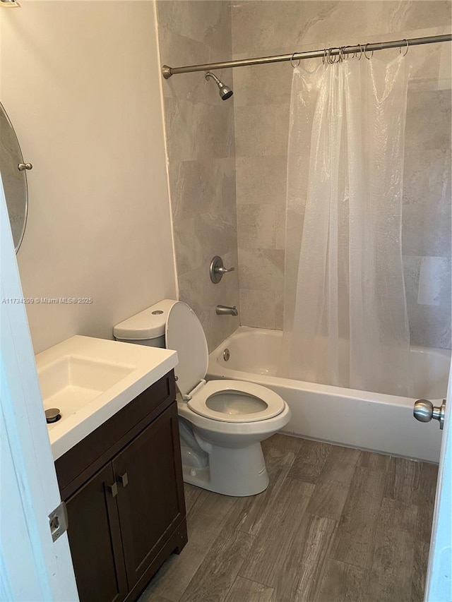 full bathroom featuring hardwood / wood-style flooring, vanity, toilet, and shower / bath combo