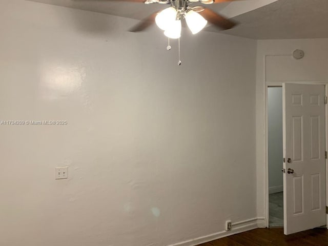 unfurnished room featuring ceiling fan and dark hardwood / wood-style flooring