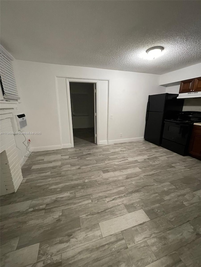 dining room with light hardwood / wood-style flooring and a textured ceiling