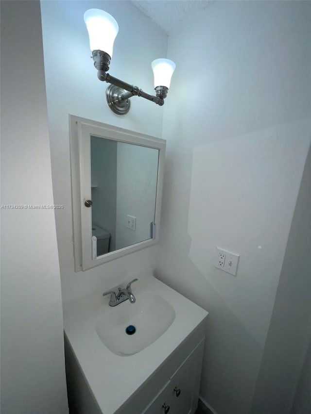 bathroom featuring vanity and toilet