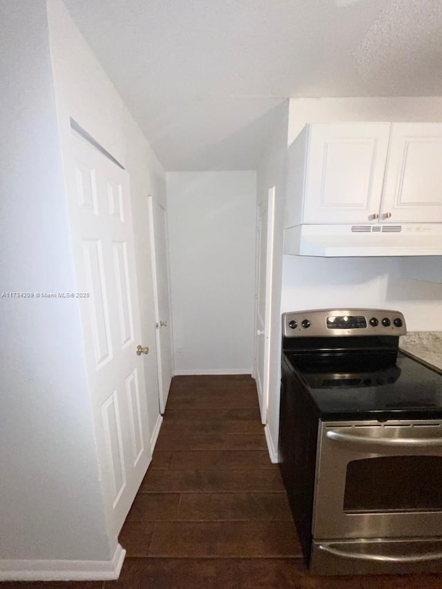 kitchen with white cabinetry, electric range, and dark wood-type flooring