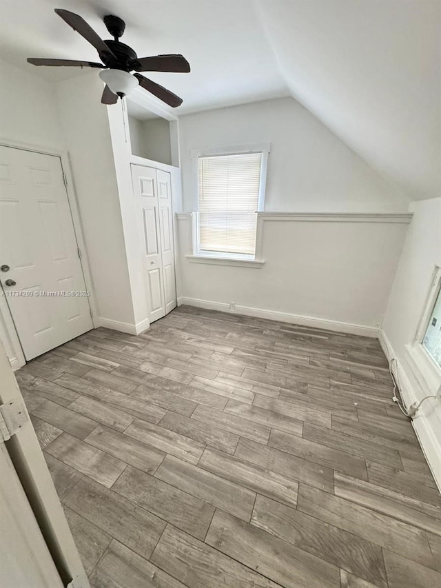 bonus room with ceiling fan, lofted ceiling, and light wood-type flooring