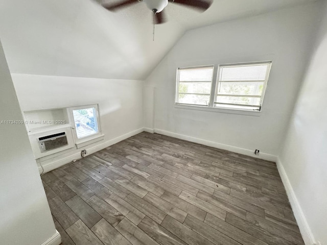 additional living space featuring wood-type flooring, vaulted ceiling, a wealth of natural light, and ceiling fan