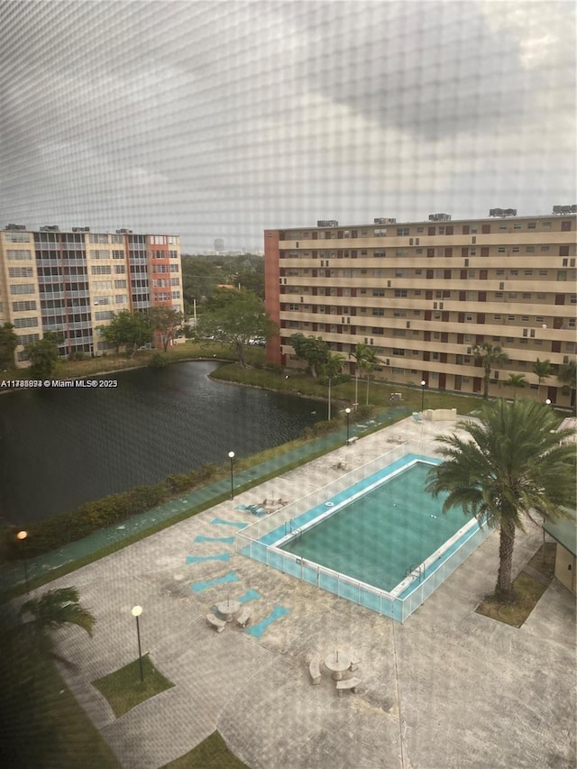 view of pool featuring a water view