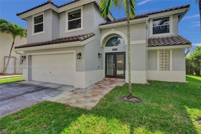 mediterranean / spanish home with a garage, a front yard, and french doors