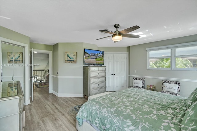 bedroom featuring light hardwood / wood-style flooring, a closet, and ceiling fan