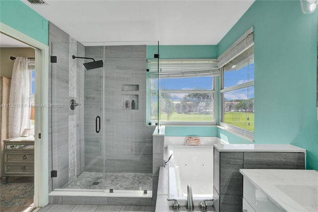 bathroom with independent shower and bath and vanity