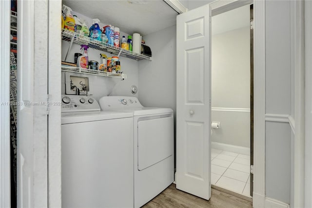 washroom featuring light wood-type flooring and washer and clothes dryer